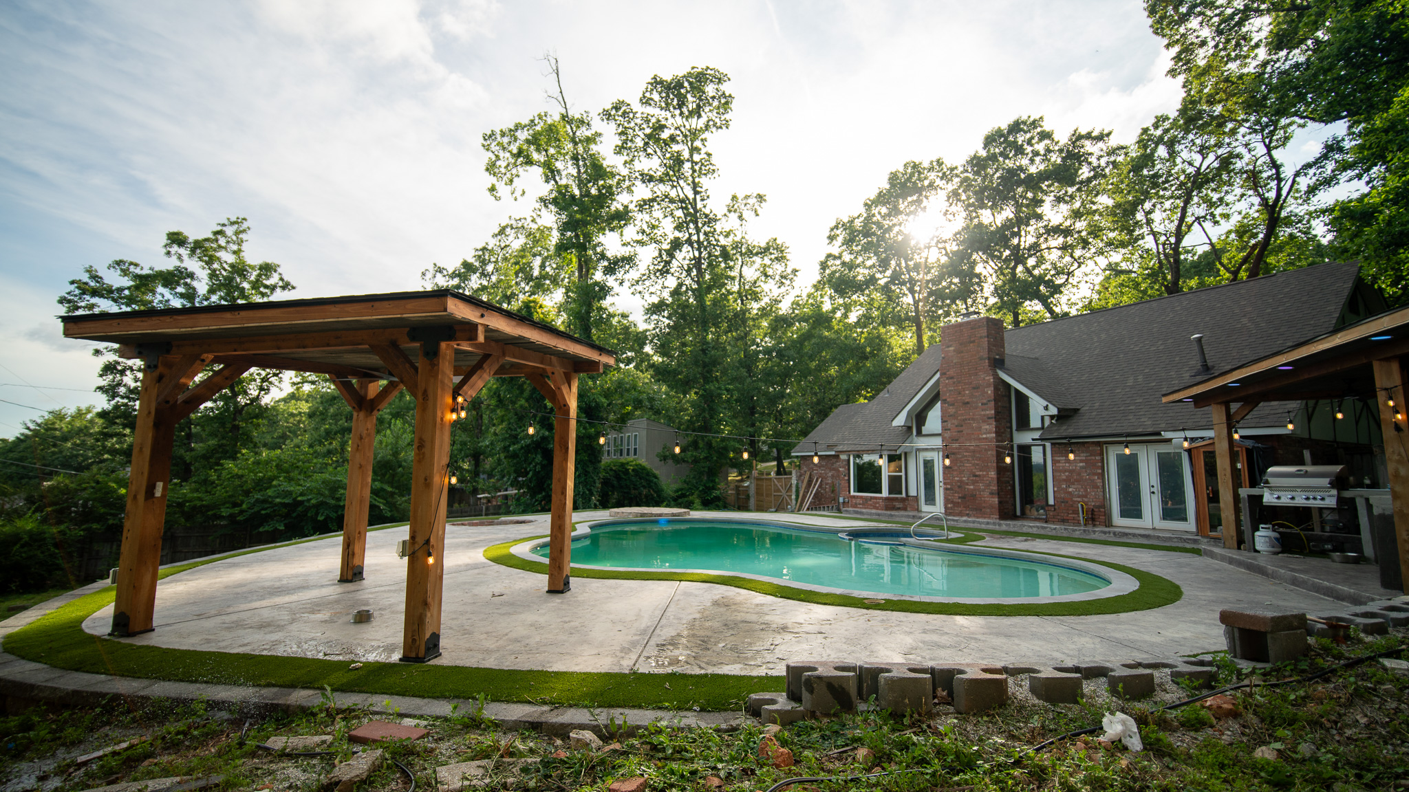 Cedar pergola beside the pool at golden hour