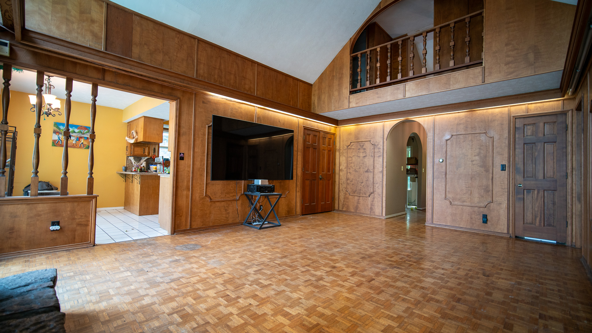 Vaulted wood great room with a loft above