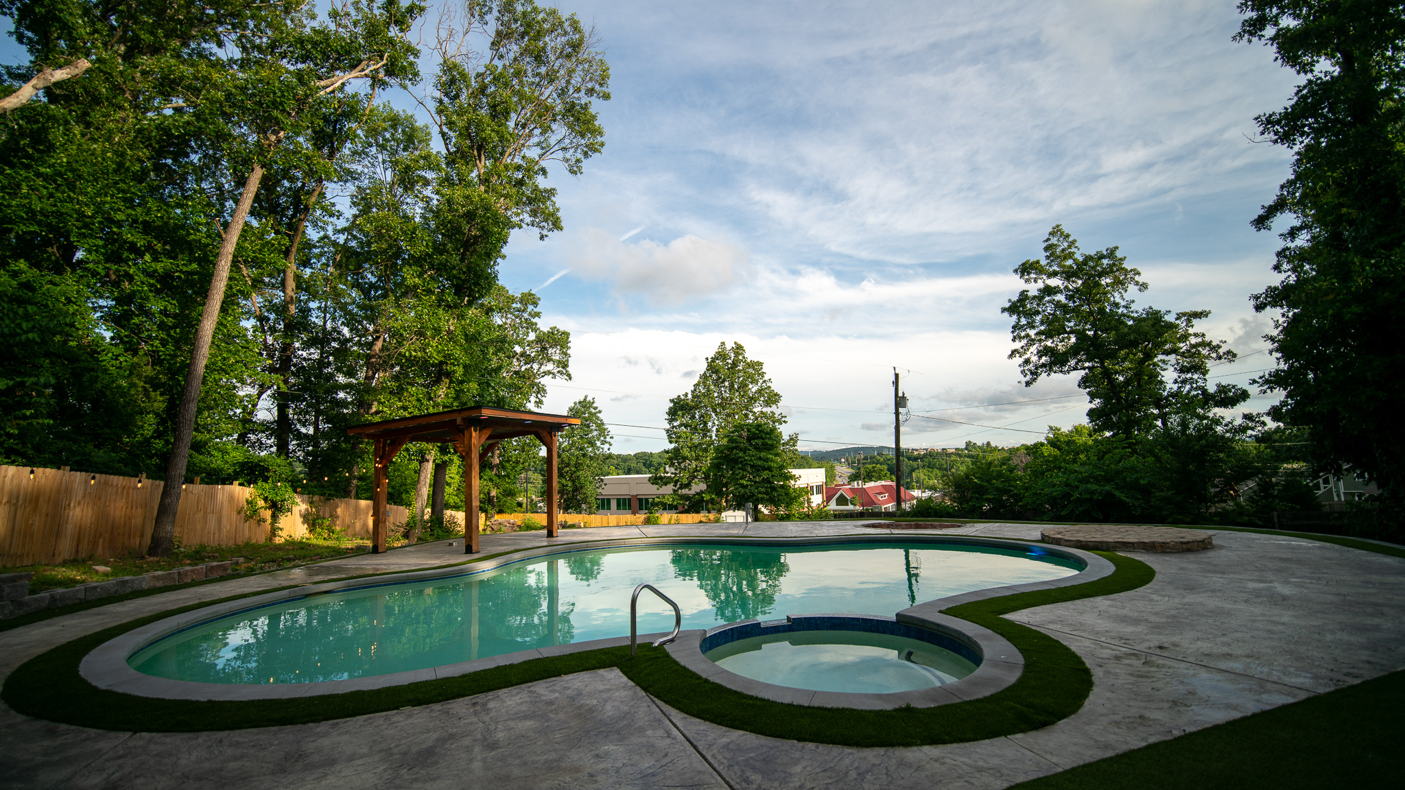 Poolside view toward the wooded tree line